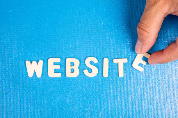 Website. Text from white wooden letters on a blue background.