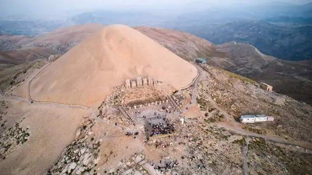 People on Nemrut Mount slope waiting for sunrise. Aerial view. Eastern terrace of Nemrut Mount, Adiyaman province, Turkey. UNESCO World Heritage Site