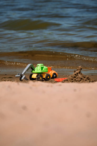 istock Toy excavator on the beach 1410766214