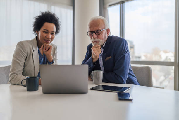 istock Focused partners analyzing business plan on laptop during office meeting. 1410766353