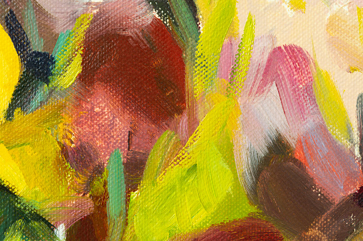 Irises yellow oil painting. Abstract artistic multicolored background. Close-up paint strokes on canvas. Conceptual cheerful picturesque background. Floral springtime background fragment of a painting