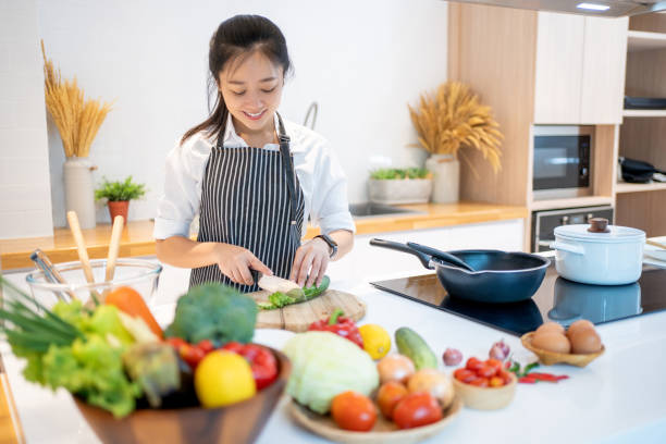 istock Young asian woman cooking in the kitchen. 1410768456