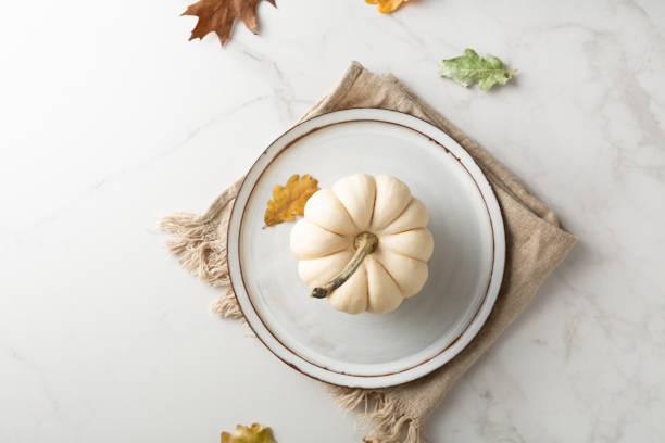 Overhead view of table setting with white pumpkin autumn concept stock photo