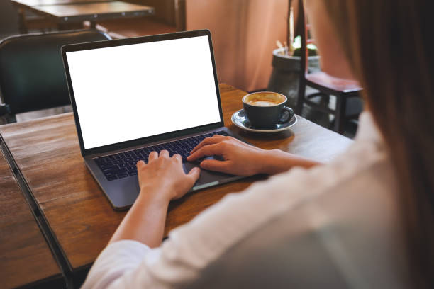 istock Mockup image of a woman using and typing on laptop computer with blank white desktop screen in cafe 1410771025