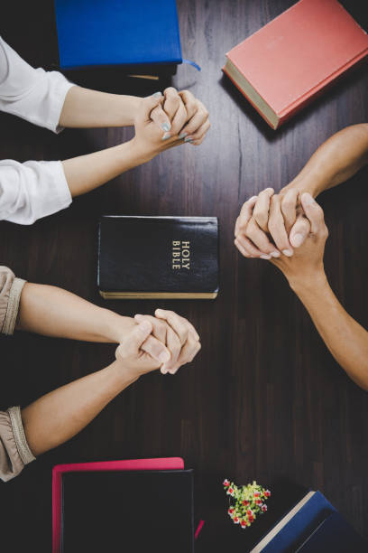 istock Group of people praying worship believe 1410771109