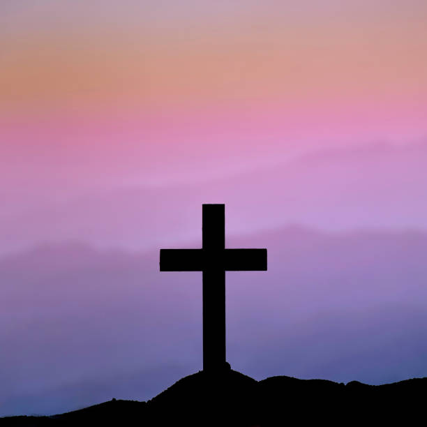 istock Silhouette Cross on the mountains 1410771257