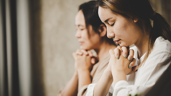 Close up portrait of hopeful woman praying
