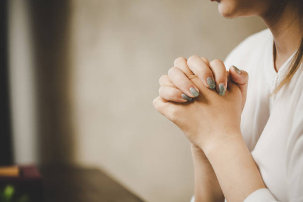 istock A woman praying worship believe 1410771395