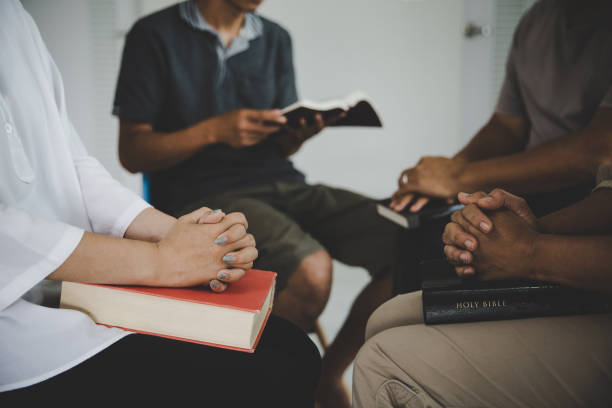 istock Group of people praying worship believe 1410771543