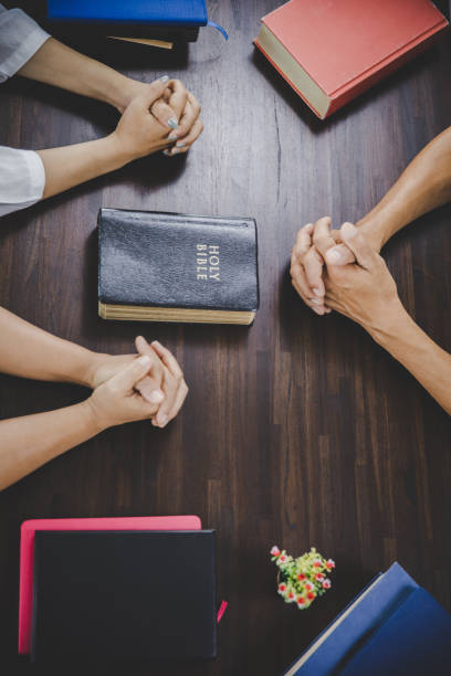 istock Group of people praying worship believe 1410772019