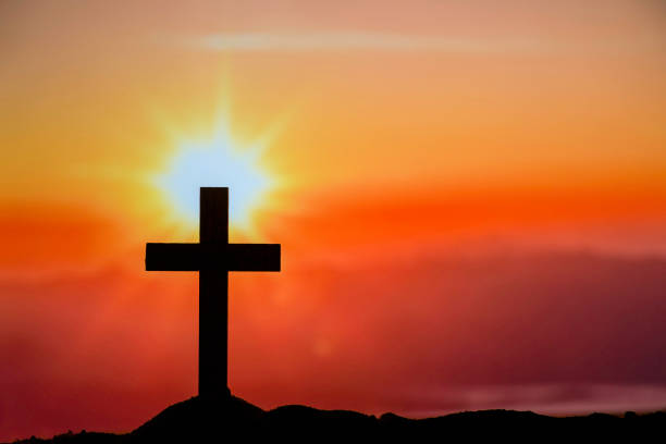 istock Silhouette Cross on the mountains 1410772906