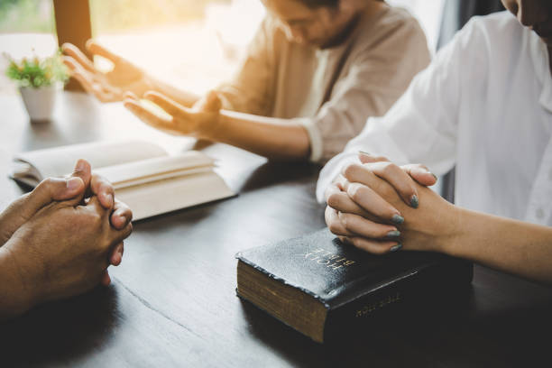 istock Group of people praying worship believe 1410772920