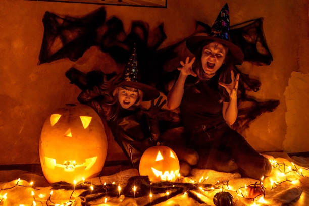 istock Mother and daughter in witch costume. Halloween. 1410774678