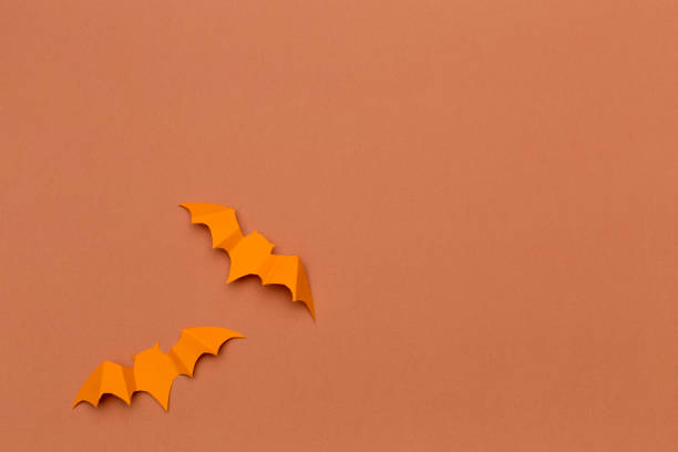 istock halloween and decoration concept - paper bats flying 1410777673