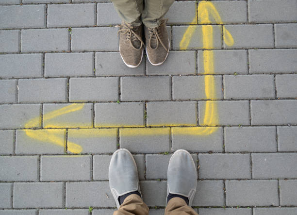 istock Arrow painted on paving slabs. 1410779852