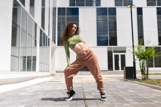 istock Young and beautiful female dancer in front of a modern building 1410781092