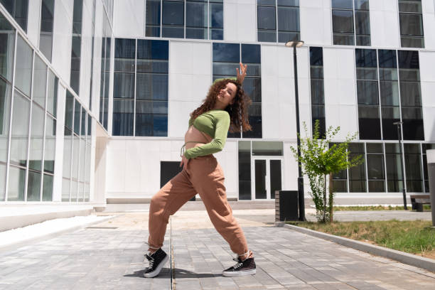 istock Young and beautiful female dancer in front of a modern building 1410781122