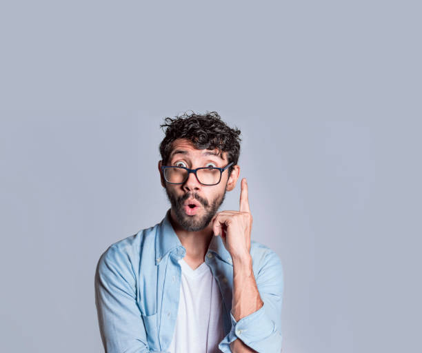 istock Amazed person pointing an advertisement up, Amazed people pointing with a hand up, Surprised man pointing up with a new idea 1410782901