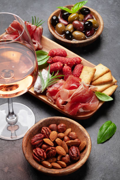 istock Antipasto board with prosciutto, salami, crackers, cheese, olives 1410783384