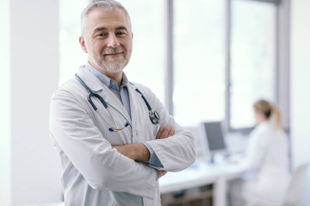 Confident doctor posing with arms crossed stock photo