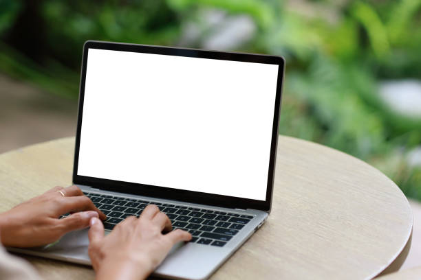 istock woman using and typing on laptop computer with blank white desktop screen on wooden table 1410783521
