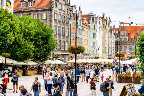 Długa street (Ulica Długa) in the centre of Gdansk old town. Old town of Gdansk, Srodmiescie historic district - tourists strolling along the Dluga street and chilling in cafes. gdansk city stock pictures, royalty-free photos & images