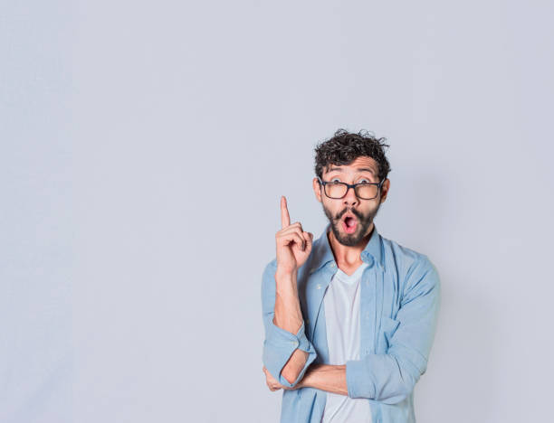 istock Surprised man pointing up with a new idea, Amazed person pointing an advertisement up, Amazed people pointing with a hand up 1410784101