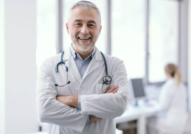 istock Confident doctor posing with arms crossed 1410785296