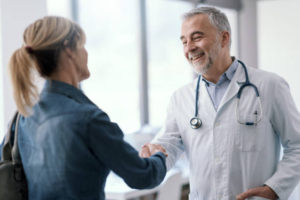 istock Doctor greeting a patient in his office 1410786171