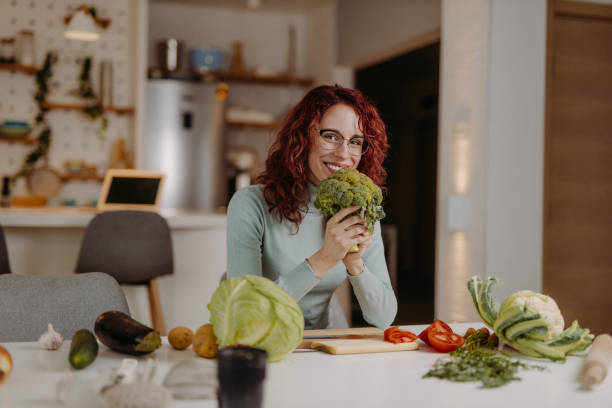 istock Young woman preparing meal at home 1410786178