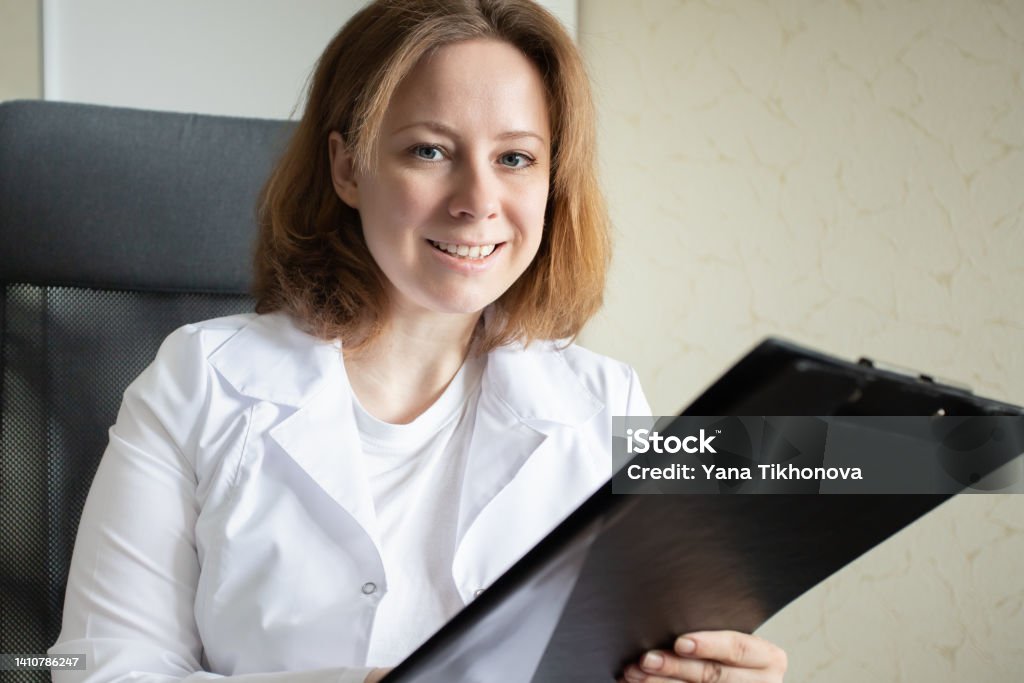 Pharmacologist, doctor in a medical clinic writes a prescription, looks at the medical history, medicine and health Hospital Stock Photo