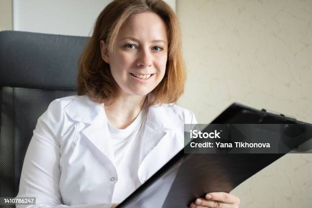 Pharmacologist Doctor In A Medical Clinic Writes A Prescription Looks At The Medical History Medicine And Health Stock Photo - Download Image Now