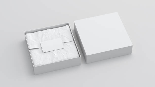 istock Square gift box mock up. White gift box with blank label or business card on wrapping paper. White background. Side view. 1410786311