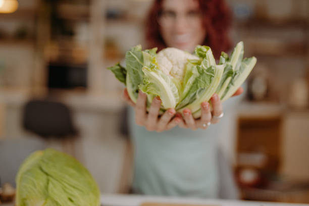 istock Young woman preparing meal at home 1410787113