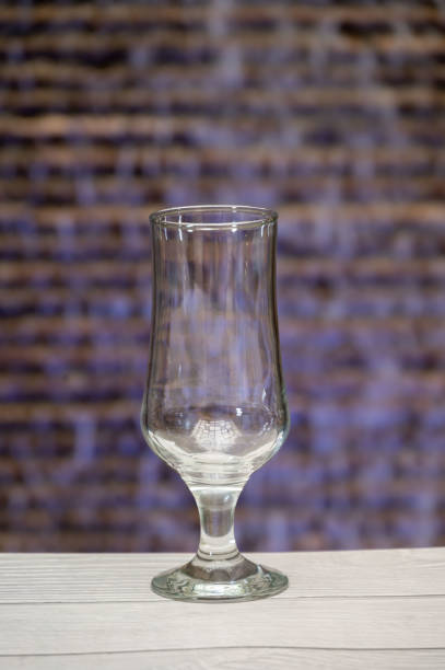 Empty glass for juice, water or ice cream on a wooden table