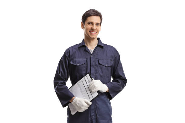 Man in a working uniform holding a clipboard stock photo