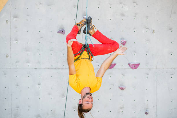 istock A man hangs upside down in a lotus position on a climbing wall 1410788989