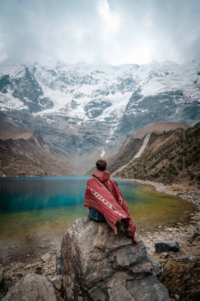 istock A young man with a poncho on vacation in Laguna Humantay, Peru 1410790864