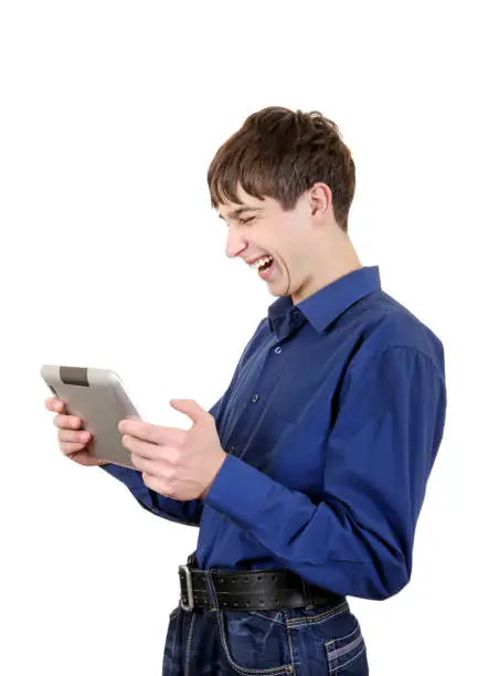 Happy Teenager with Tablet Computer Laughing on the White Background