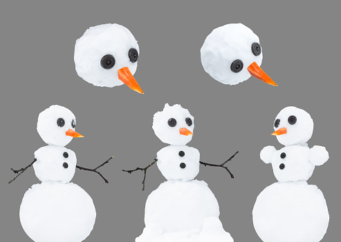 Snowmans with button eyes and a carrot nose. Isolated on a gray background