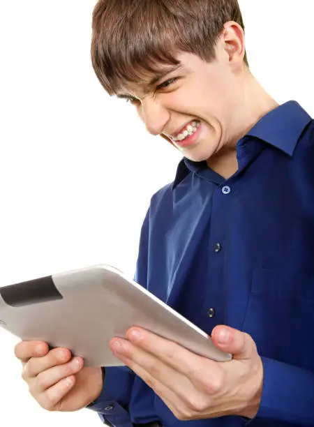 Angry Teenager with Tablet Computer Isolated on the White Background