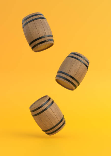 barils en bois en vol sur fond jaune - oak barrel photos et images de collection