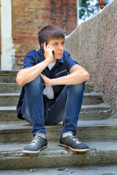 istock Sad Teenager with Cellphone 1410795048