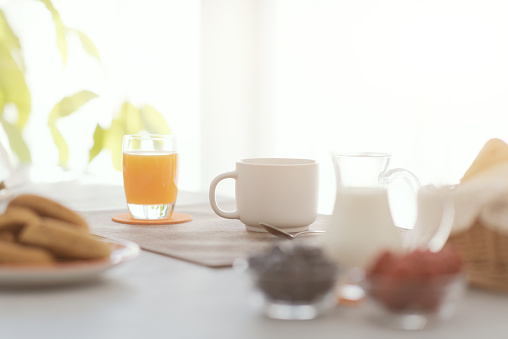 Delicious breakfast at home: fresh fruit and coffee on the kitchen table