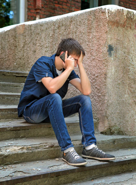 istock Sad Young Man with Cellphone 1410795314