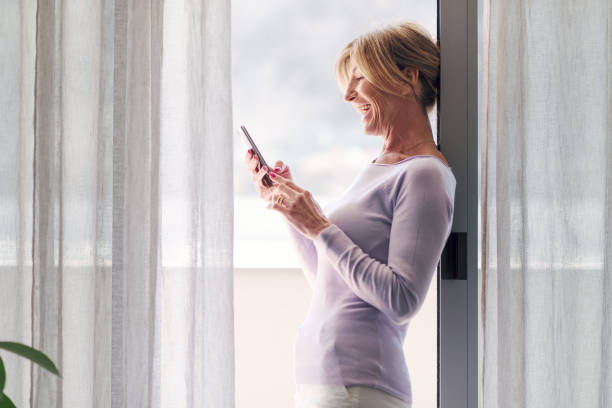 istock Happy woman connecting with her smartphone 1410795754