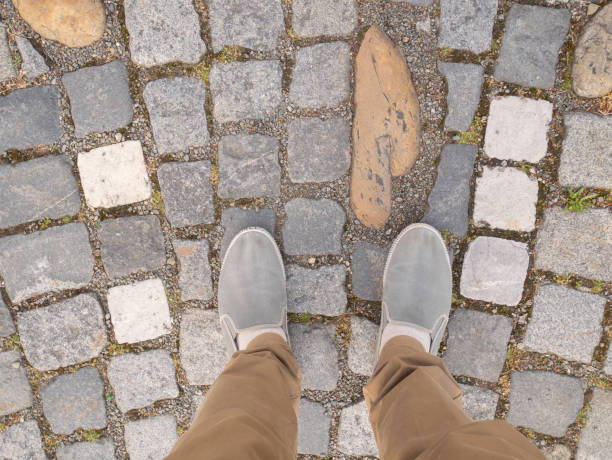 istock Feet on the paving stones in the square. 1410796743