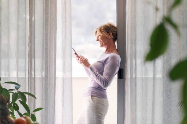 istock Happy woman connecting with her smartphone 1410796909