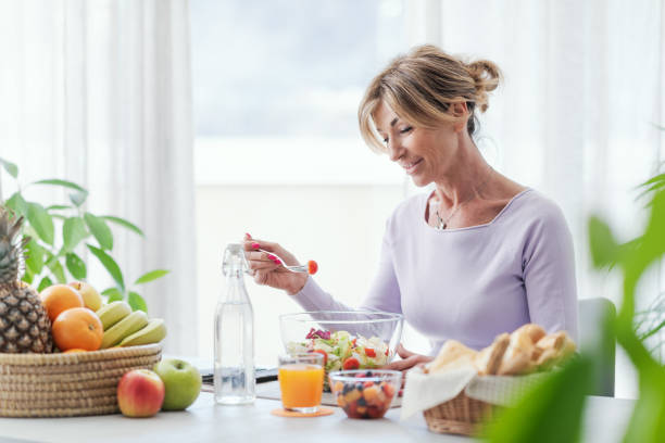 istock Happy mature woman having lunch break 1410796951