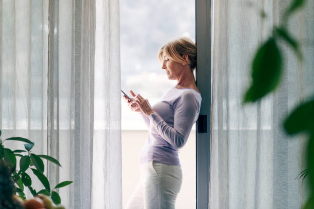 istock Happy woman connecting with her smartphone 1410797008